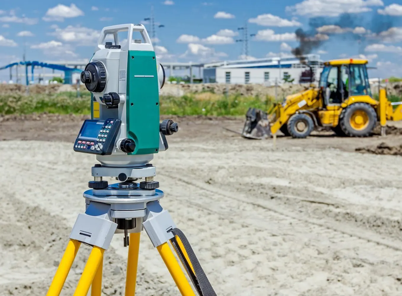 Total station on a tripod at a construction site in Botswana